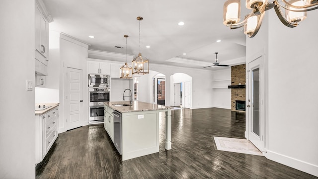 114 N Star Crossing Ln, Weatherford, TX 76088 - kitchen with a sink, stainless steel appliances, a large fireplace, open floor plan, and arched walkways