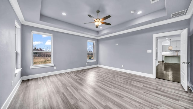 114 N Star Crossing Ln, Weatherford, TX 76088 - unfurnished bedroom featuring a tray ceiling, visible vents, wood finished floors, and baseboards