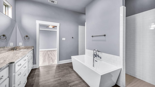 114 N Star Crossing Ln, Weatherford, TX 76088 - bathroom with a walk in shower, visible vents, a freestanding tub, ceiling fan, and vanity