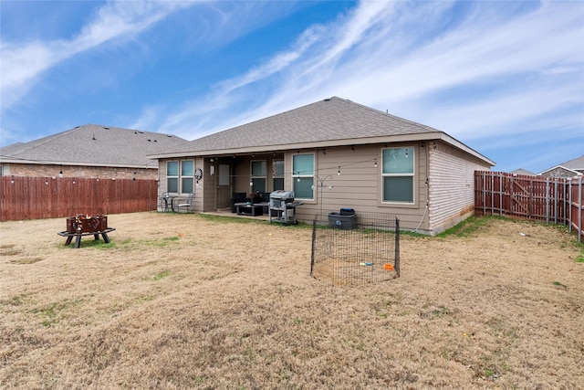 back of property featuring a yard