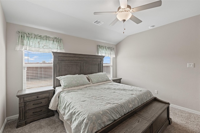 bedroom with vaulted ceiling, multiple windows, and light carpet