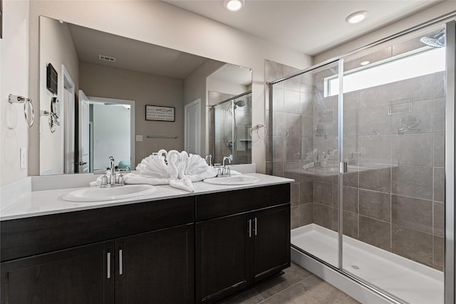 bathroom featuring tile patterned floors, vanity, and an enclosed shower