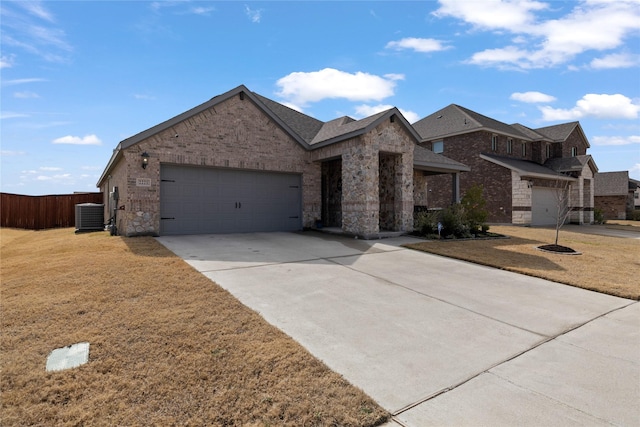 view of front of house with a front lawn, cooling unit, and a garage