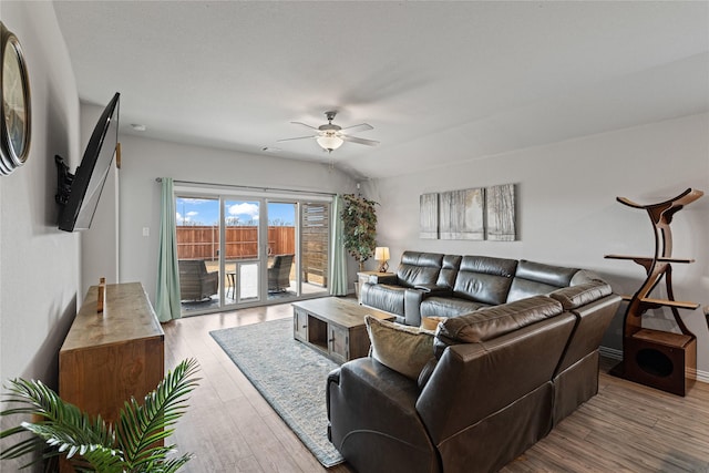 living room with ceiling fan and light hardwood / wood-style flooring