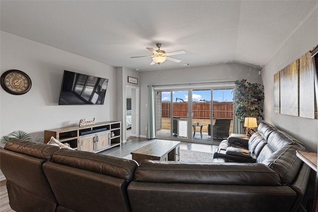 living room featuring hardwood / wood-style floors, vaulted ceiling, and ceiling fan