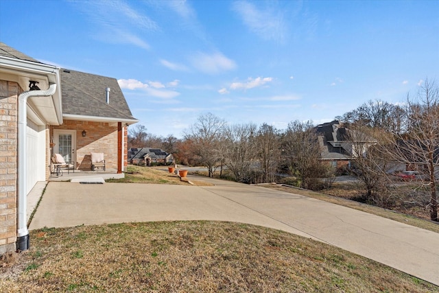 view of yard with a patio and a garage