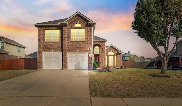 view of property featuring a yard and a garage