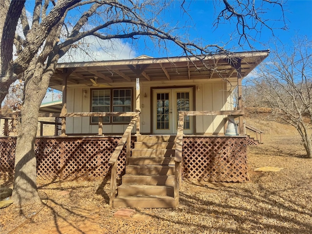 rear view of property featuring covered porch