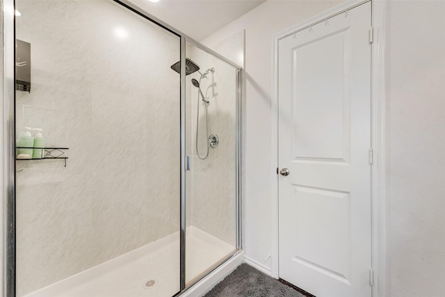 bathroom featuring a shower with shower door