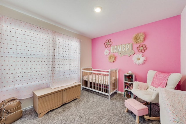 carpeted bedroom with a nursery area