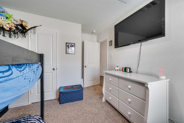 bedroom with light carpet