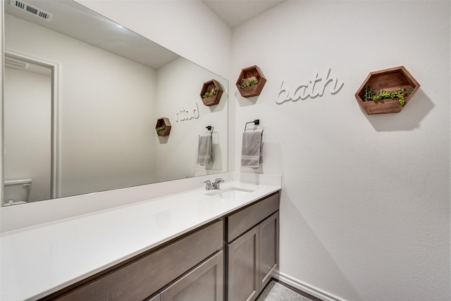 bathroom with toilet and vanity