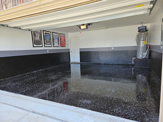 garage featuring a garage door opener and water heater