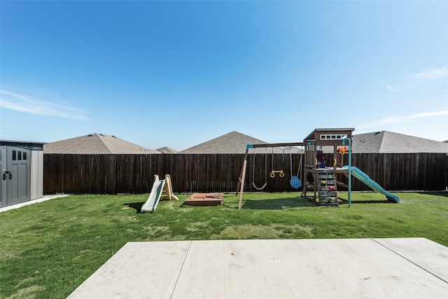 view of yard with a shed, a playground, and a patio area