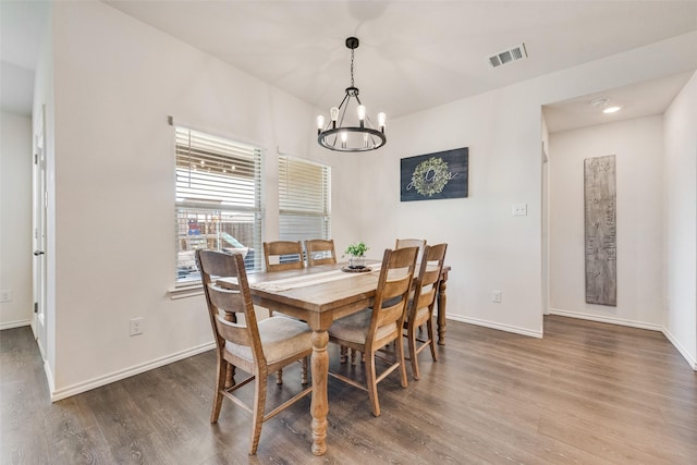 dining space featuring a notable chandelier and wood-type flooring