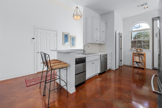 kitchen featuring a kitchen breakfast bar, decorative light fixtures, backsplash, sink, and white cabinetry