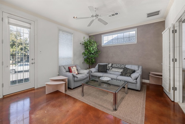 living room featuring ornamental molding, ceiling fan, and concrete floors