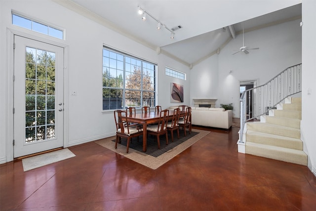 dining room featuring track lighting, high vaulted ceiling, ceiling fan, and beam ceiling