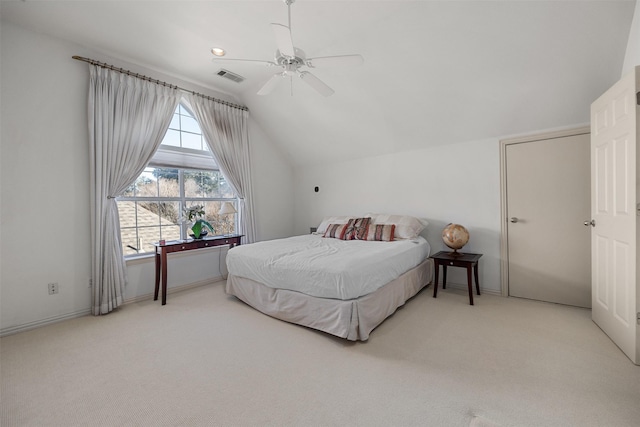 bedroom featuring light carpet, lofted ceiling, and ceiling fan