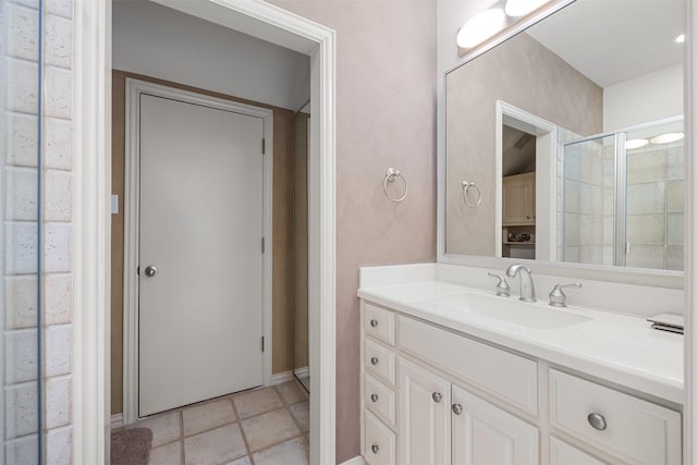 bathroom featuring vanity and a shower with door