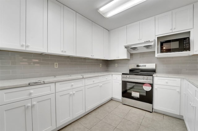 kitchen featuring under cabinet range hood, white cabinets, black microwave, and electric range