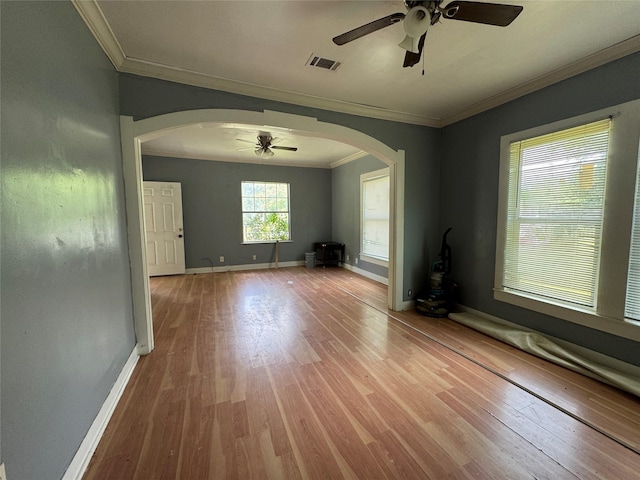 2917 Walnut St, Greenville, TX 75401 - unfurnished room with ceiling fan, arched walkways, crown molding, wood finished floors, and baseboards