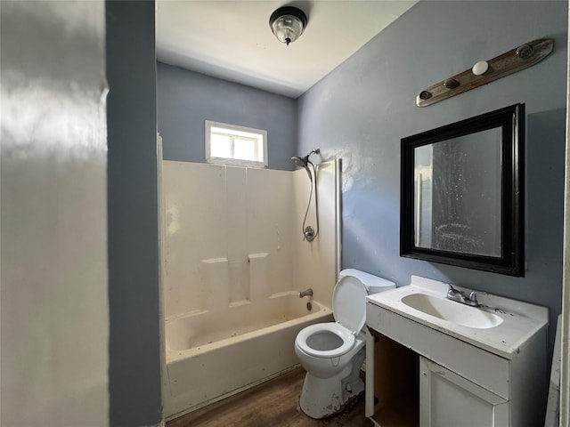 2917 Walnut St, Greenville, TX 75401 - bathroom featuring toilet, wood finished floors, vanity, and shower / washtub combination
