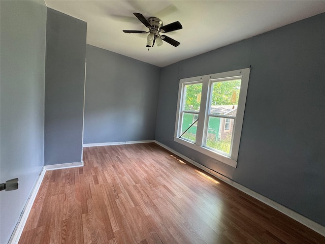 2917 Walnut St, Greenville, TX 75401 - spare room featuring wood finished floors, baseboards, and a ceiling fan
