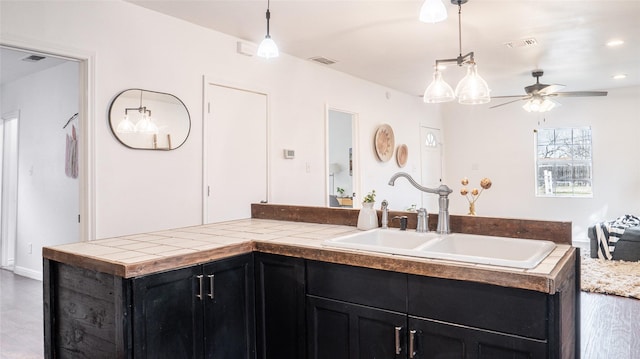 interior space with ceiling fan and vanity