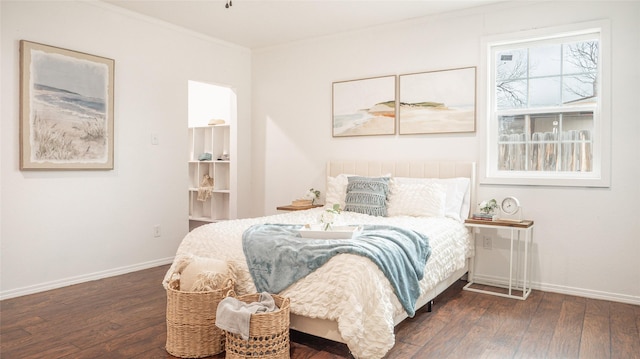 bedroom featuring ornamental molding and dark hardwood / wood-style floors