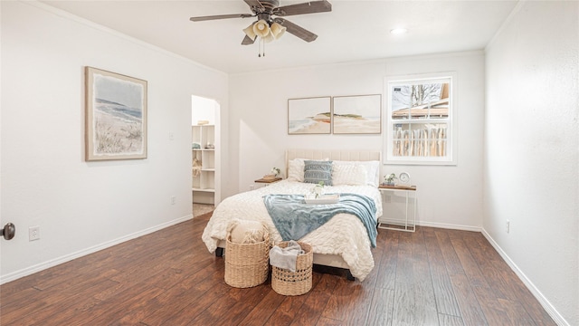 bedroom with crown molding, dark wood-type flooring, and ceiling fan