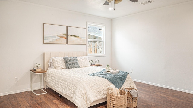 bedroom with crown molding, dark wood-type flooring, and ceiling fan