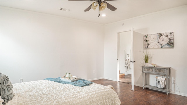 bedroom featuring ceiling fan, dark hardwood / wood-style floors, and ornamental molding