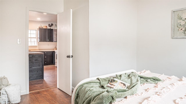 bedroom with dark hardwood / wood-style floors