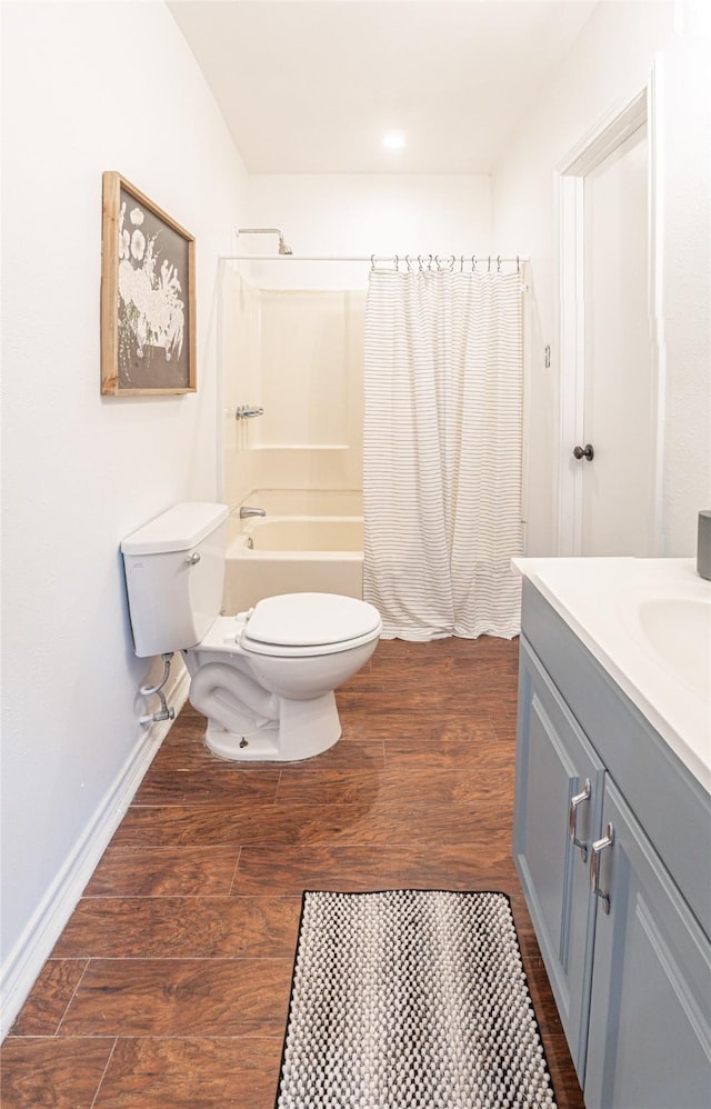 full bathroom featuring toilet, vanity, wood-type flooring, and shower / bath combo with shower curtain