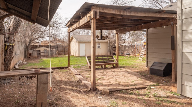 view of yard featuring a patio and a storage shed