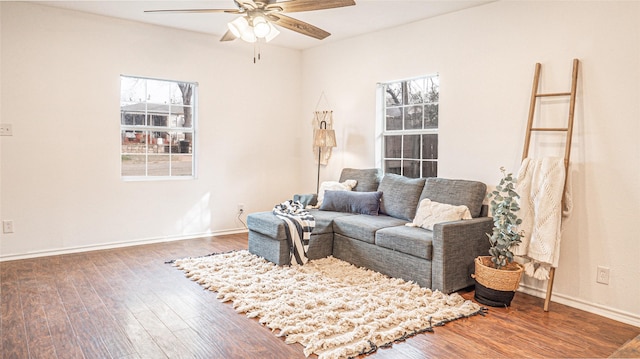 living room with ceiling fan and dark hardwood / wood-style flooring