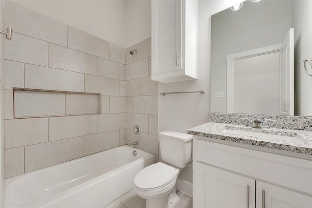 full bathroom featuring toilet, vanity, and tiled shower / bath