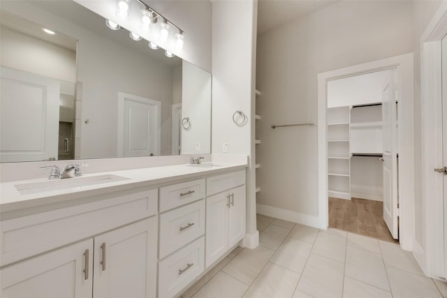 bathroom featuring tile patterned floors, vanity, and a shower with shower door