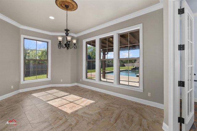 spare room with crown molding and an inviting chandelier