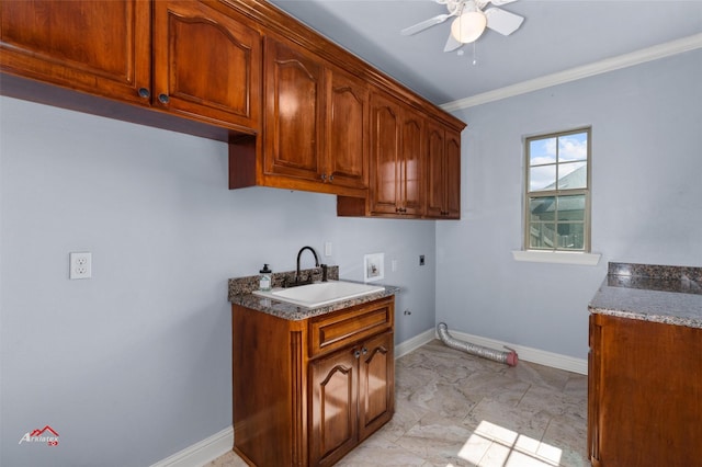 washroom featuring washer hookup, sink, cabinets, crown molding, and hookup for an electric dryer