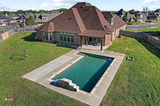 view of pool featuring a yard and a patio area