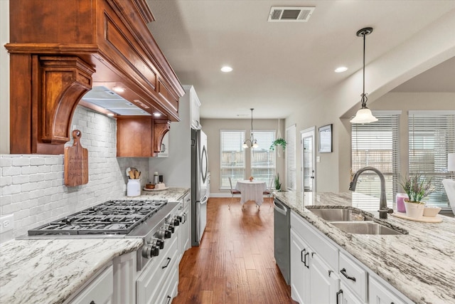 kitchen featuring white cabinetry, sink, pendant lighting, and appliances with stainless steel finishes