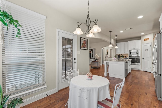 dining room featuring a chandelier and dark hardwood / wood-style flooring