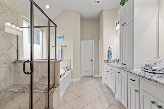 bathroom featuring plus walk in shower, vanity, vaulted ceiling, and tile patterned floors