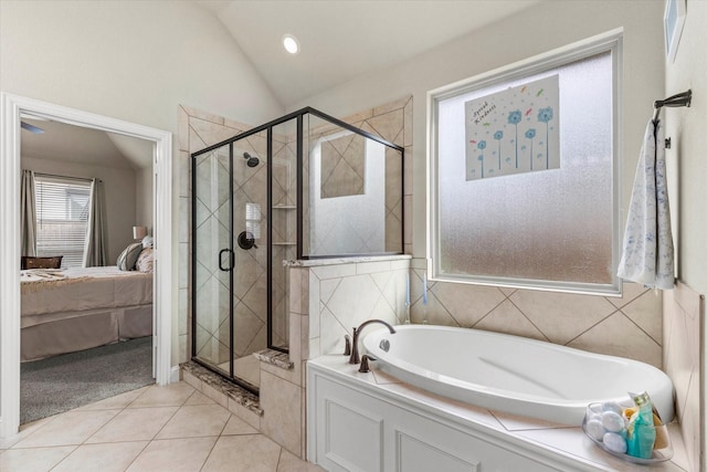 bathroom with tile patterned floors, lofted ceiling, and independent shower and bath