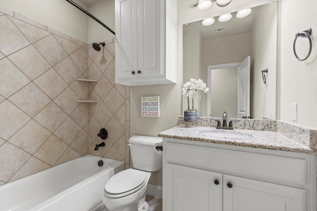 full bathroom with tiled shower / bath combo, vanity, and toilet