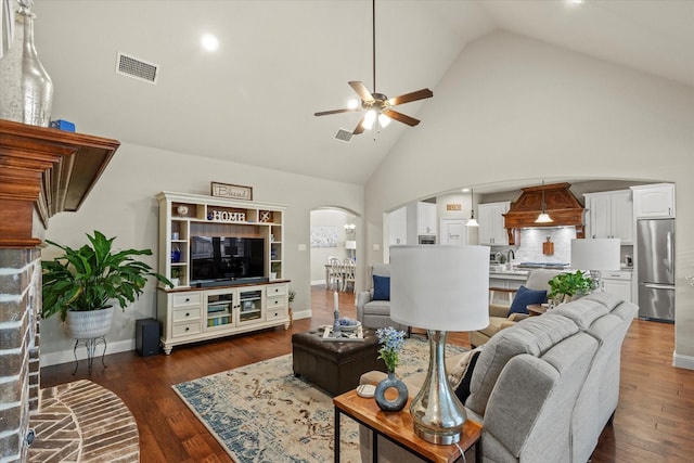 living room featuring ceiling fan, high vaulted ceiling, and dark hardwood / wood-style flooring