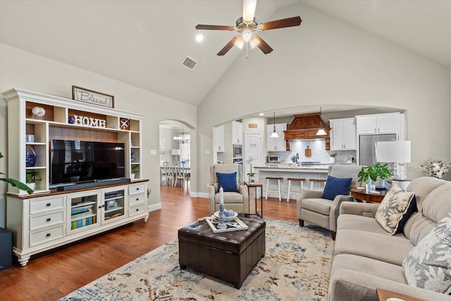 living room featuring sink, dark wood-type flooring, high vaulted ceiling, and ceiling fan