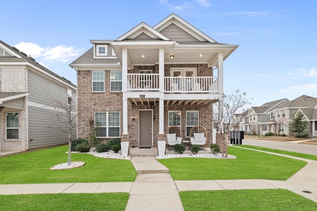 10012 Travis Dr, Providence Village, TX 76227 - view of front facade with a balcony, brick siding, a front lawn, and a porch